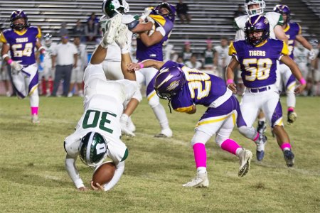 Jason McDonald with a convincing tackled against Dinuba on Friday night.
